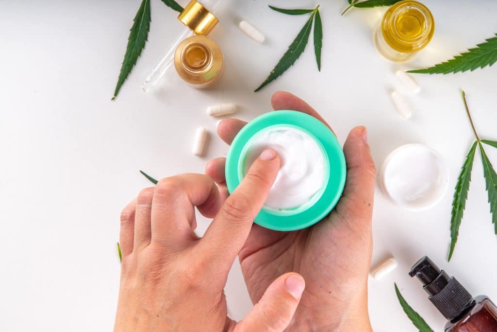 Person applying CBD oil cream